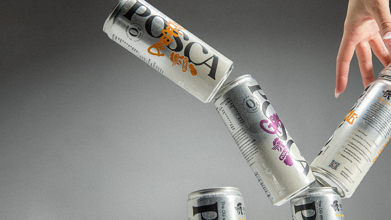 Three Posca Hydrate cans falling against a grey background