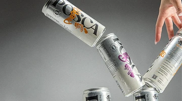 Three Posca Hydrate cans falling against a grey background