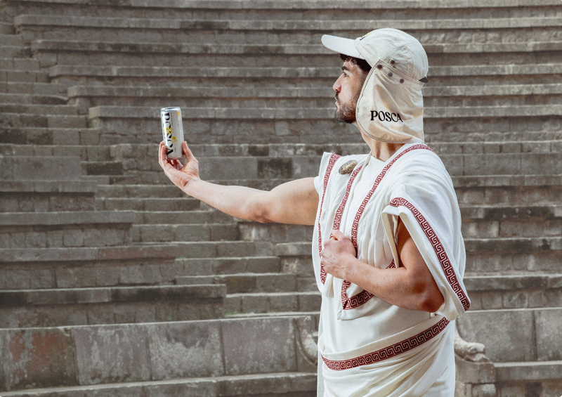 Ancient roman man holding a can of Posca Hydrate (and wearing a legionnaires running cap)
