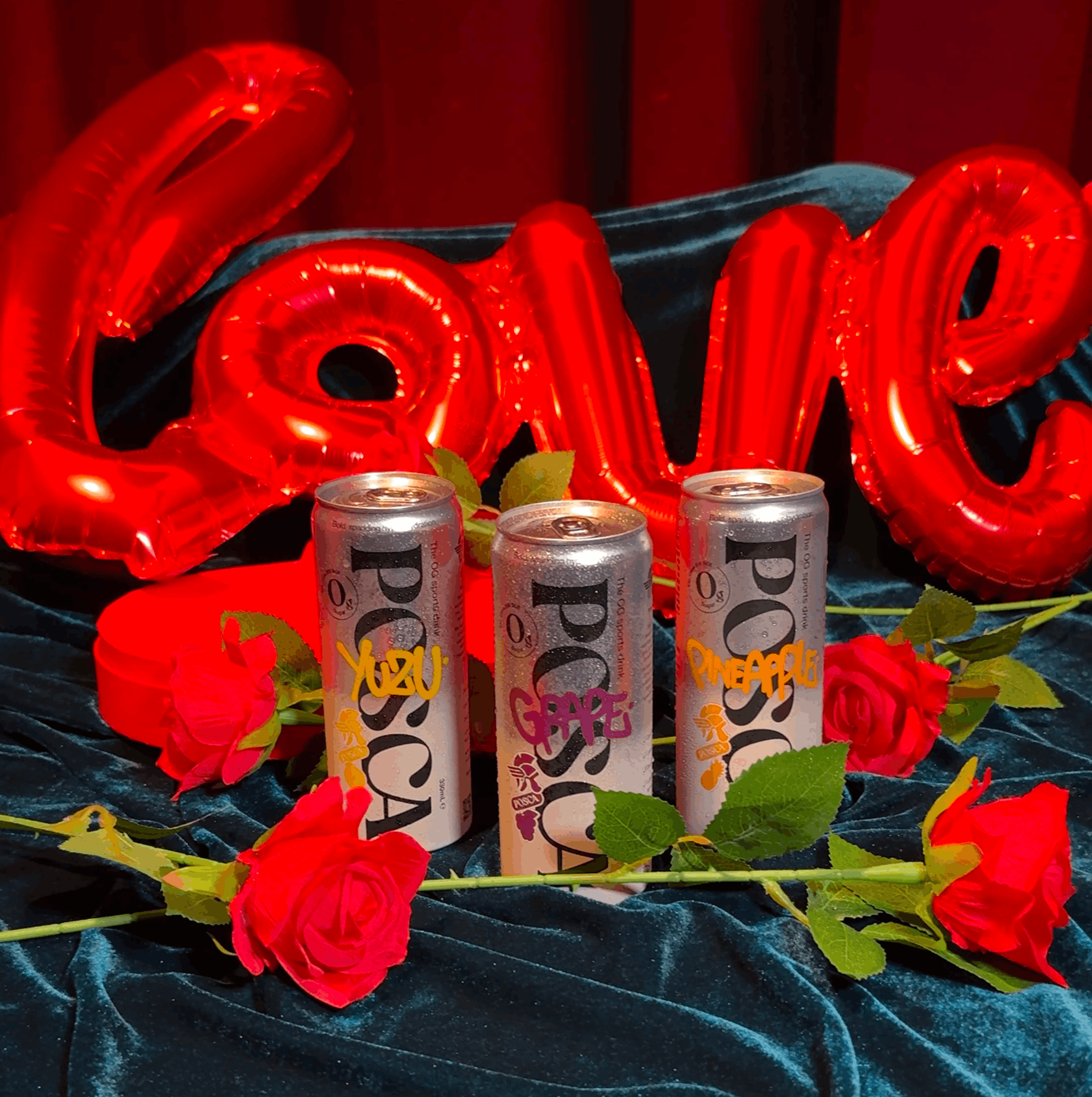 Three cans of POSCA with red 'LOVE' balloons and roses on a dark background